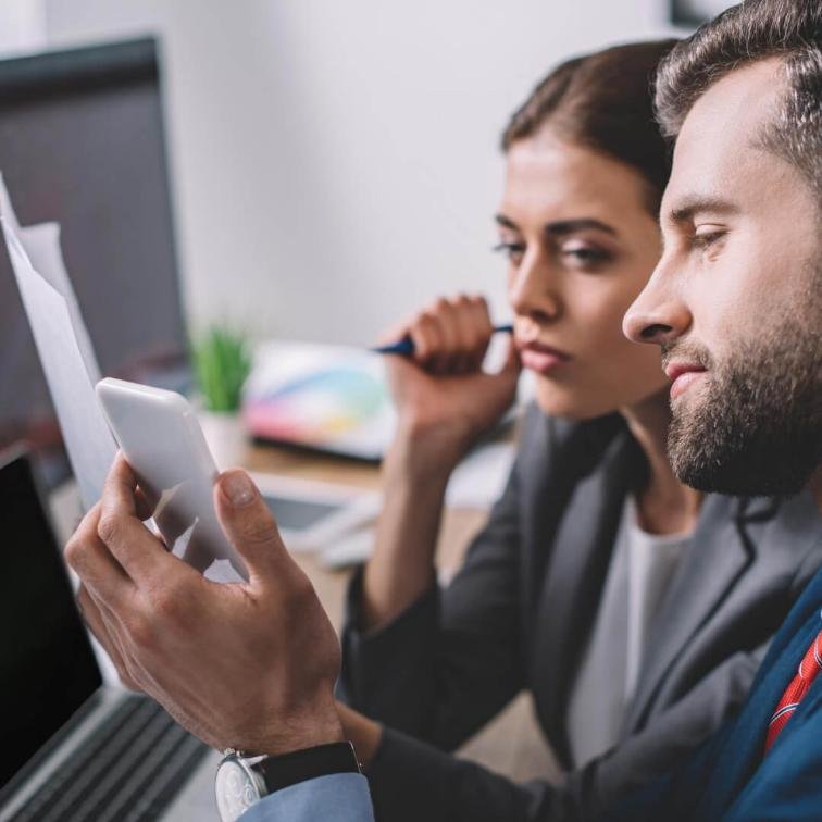 man and a woman monitoring data