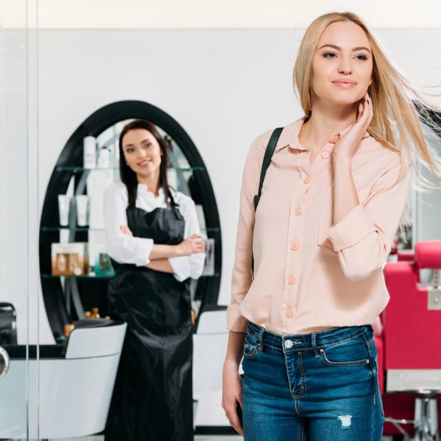 woman happy with her hairstyle after visiting the salon