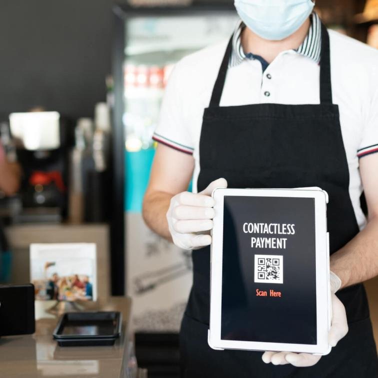 server holding a menu with qr code